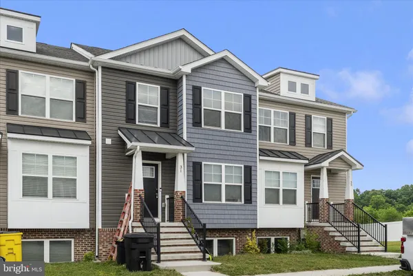 a front view of a residential apartment building with a yard