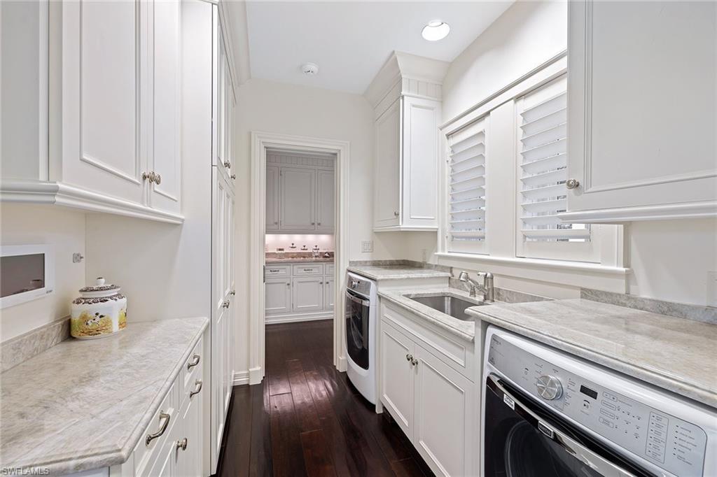 163 10th Avenue South Naples, FL 34102 - Photo 17 of 50 a kitchen with a sink stove top oven and cabinets