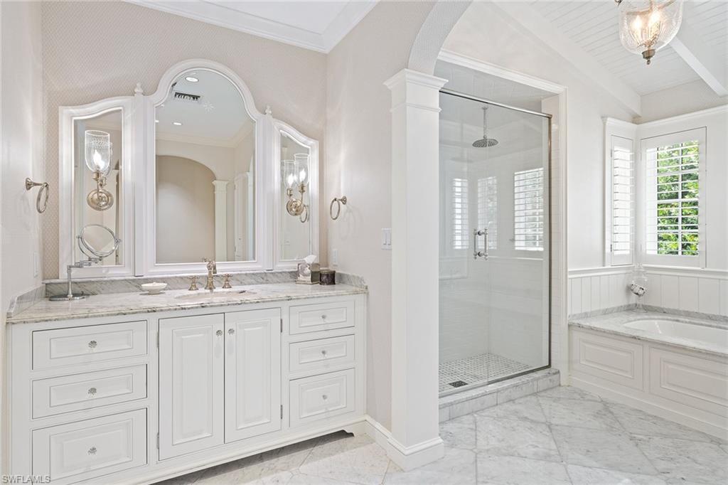 163 10th Avenue South Naples, FL 34102 - Photo 22 of 50 a spacious bathroom with a granite countertop sink a mirror and a