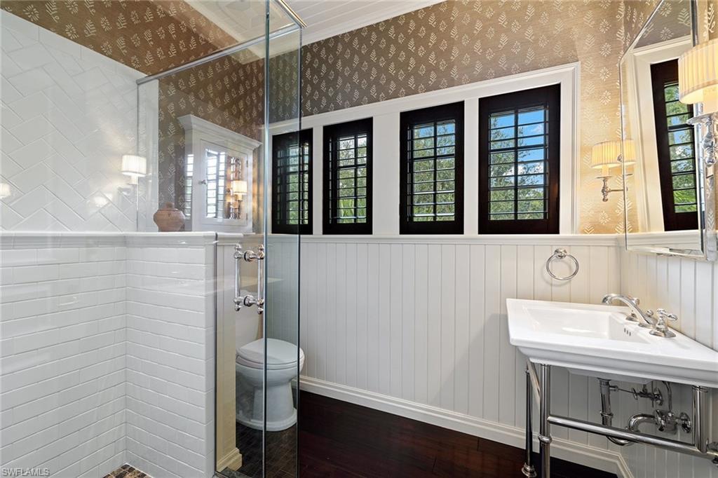 163 10th Avenue South Naples, FL 34102 - Photo 26 of 50 a bathroom with a sink and a mirror