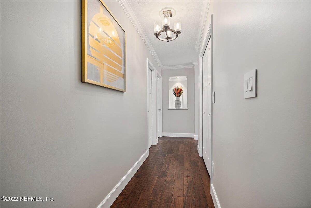 9410 Woodhaven Road Jacksonville, FL 32257 - Photo 18 of 27 a view of a hallway with wooden floor and a window