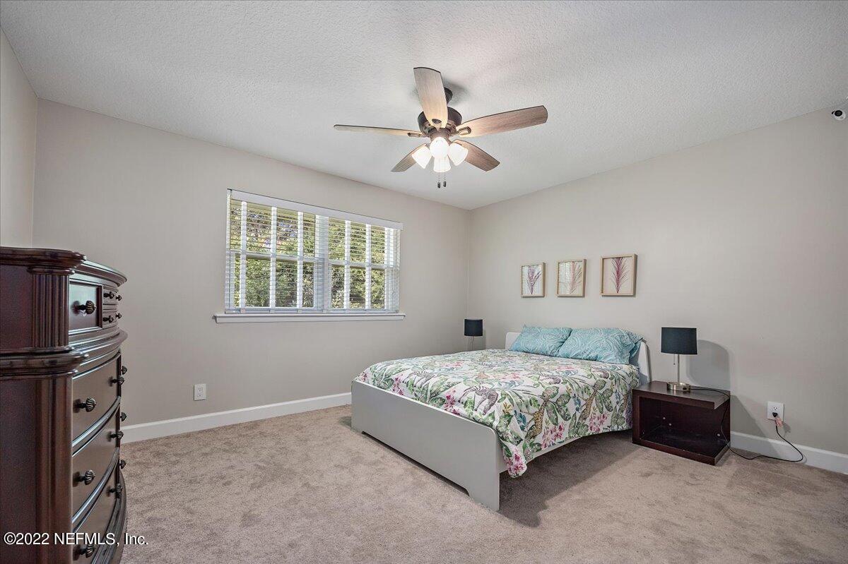 9410 Woodhaven Road Jacksonville, FL 32257 - Photo 21 of 27 a bedroom with a bed dresser and a window
