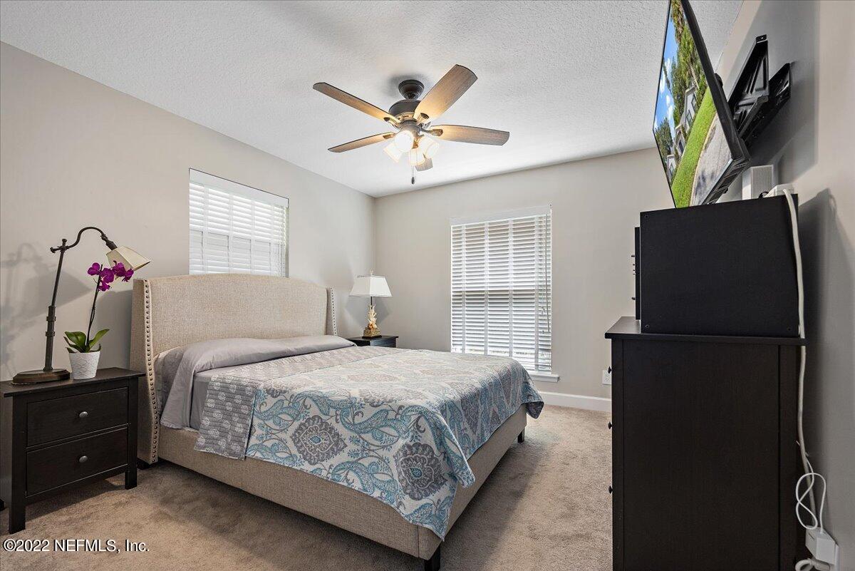 9410 Woodhaven Road Jacksonville, FL 32257 - Photo 23 of 27 a bedroom with a bed dresser and a window
