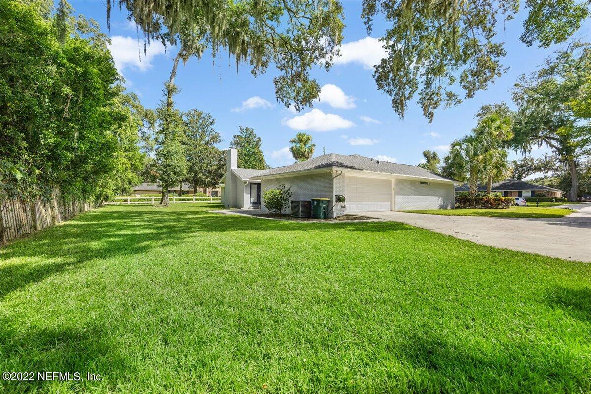 9410 Woodhaven Road Jacksonville, FL 32257 - Photo 26 of 27 a front view of a house with a yard