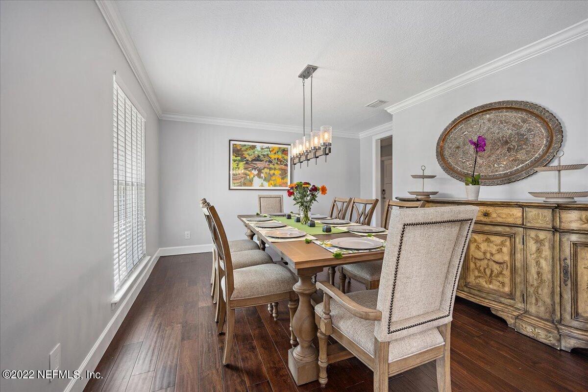 9410 Woodhaven Road Jacksonville, FL 32257 - Photo 5 of 27 a view of a dining room with furniture and a chandelier