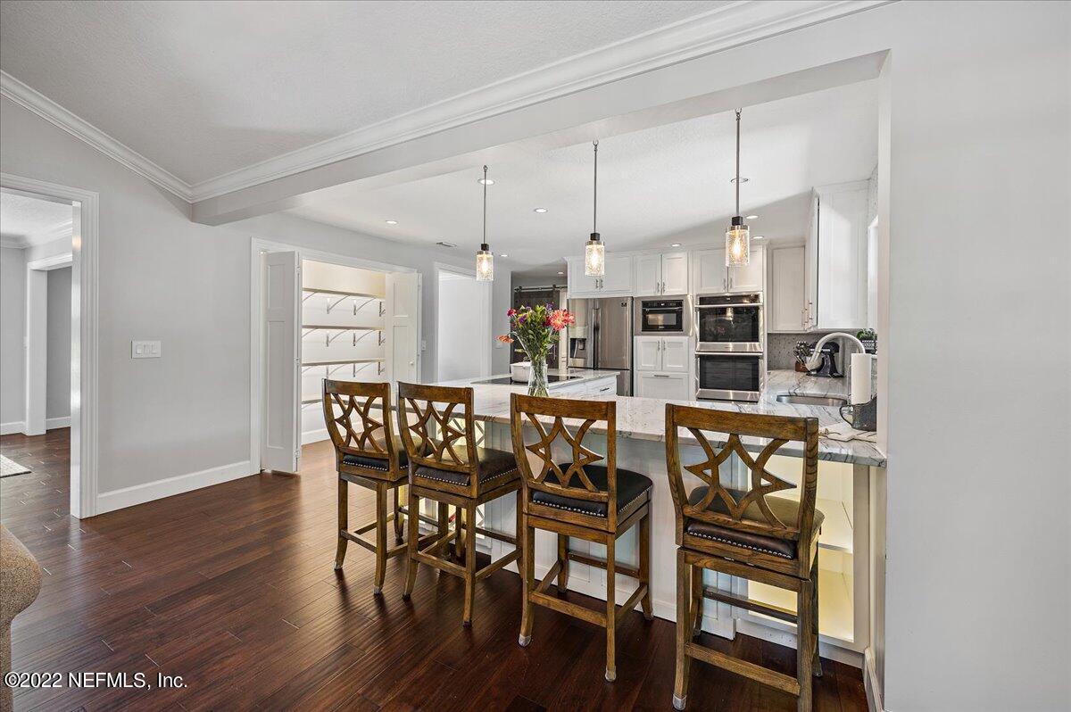 9410 Woodhaven Road Jacksonville, FL 32257 - Photo 8 of 27 a view of a dining room with furniture and wooden floor