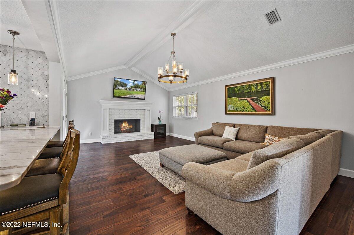 9410 Woodhaven Road Jacksonville, FL 32257 - Photo 10 of 27 a living room with furniture and a fireplace