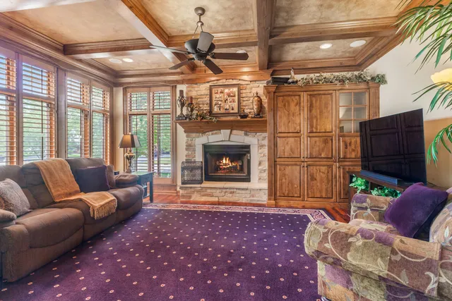 a living room with furniture a fireplace and wooden floor
