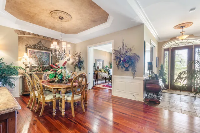 a view of a dining room with furniture wooden floor and chandelier