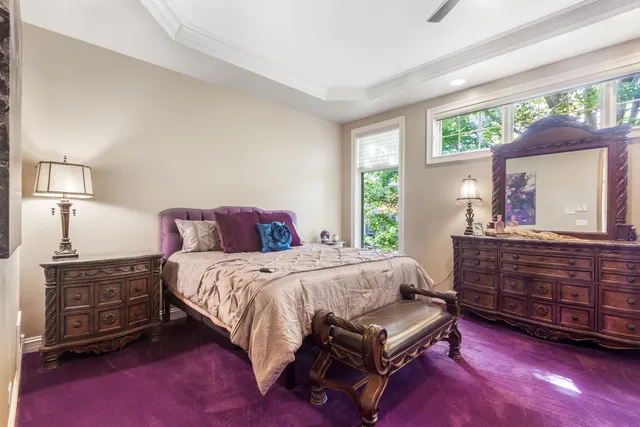 a bedroom with a bed dresser and a window