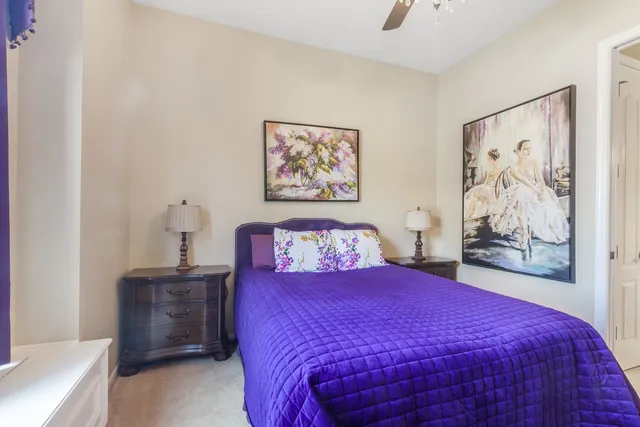 a bedroom with a bed and a painting on the wall