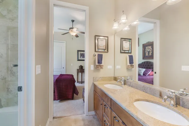 a en suite bathroom with a double vanity sink a mirror and a shower