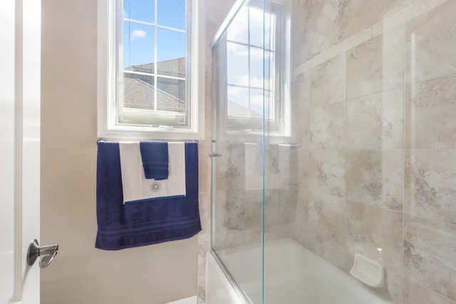 a bathroom with a shower and mirror