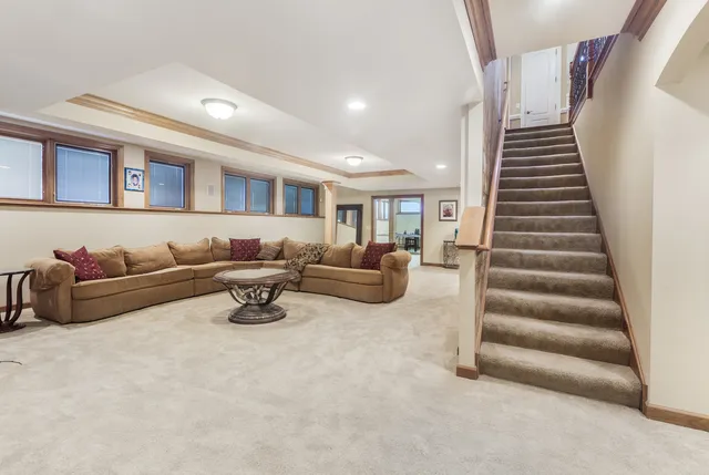 a living room with furniture and stairs