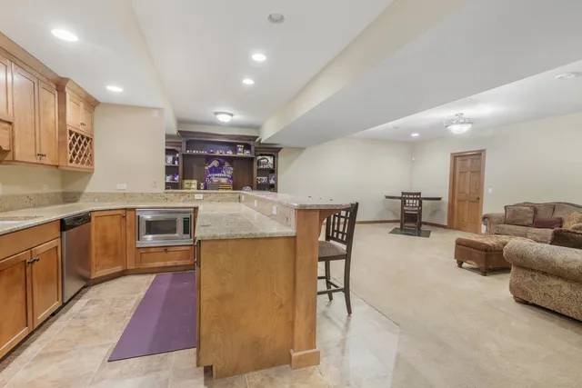 a kitchen with a sink a counter top space stainless steel appliances and cabinets