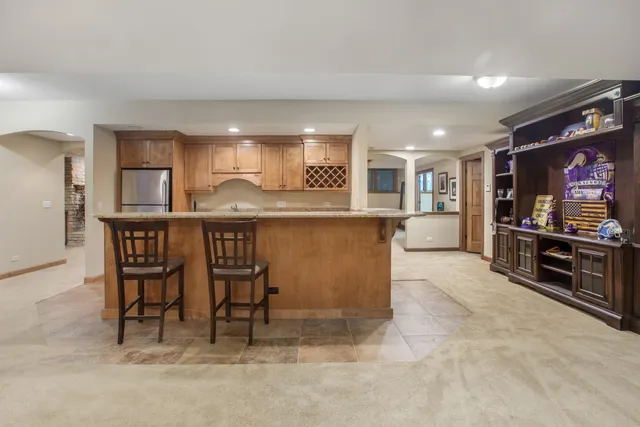 a kitchen with kitchen island granite countertop a stove and a refrigerator