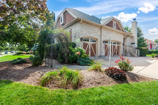 a front view of a house with a yard and outdoor seating