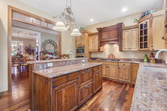 a kitchen with stainless steel appliances granite countertop a sink stove and cabinets