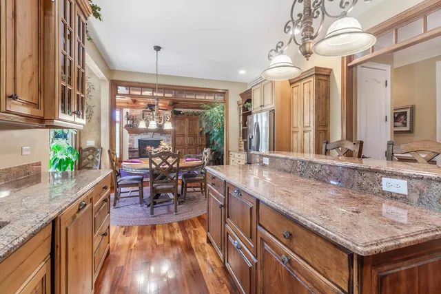 a dining table with chairs and chandelier