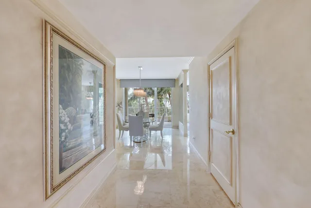 a dining room with furniture a chandelier and window
