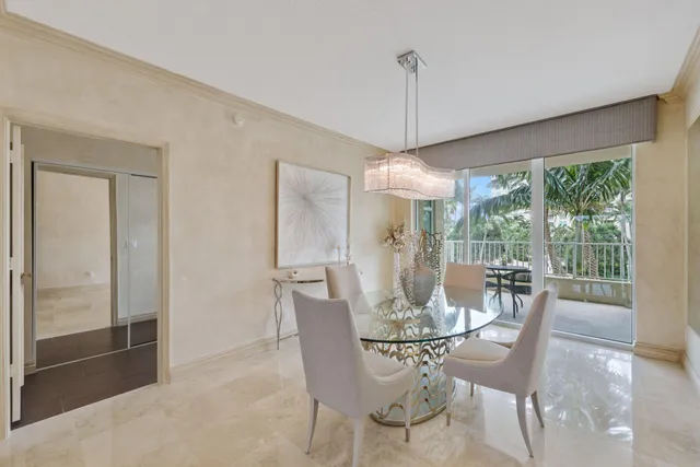 a dining room with furniture a chandelier and wooden floor