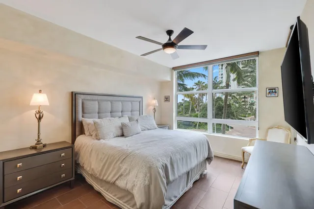 a view of a balcony with potted plants and a bench