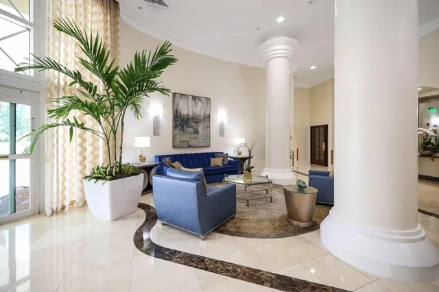 a front view of a house with swimming pool and sitting space