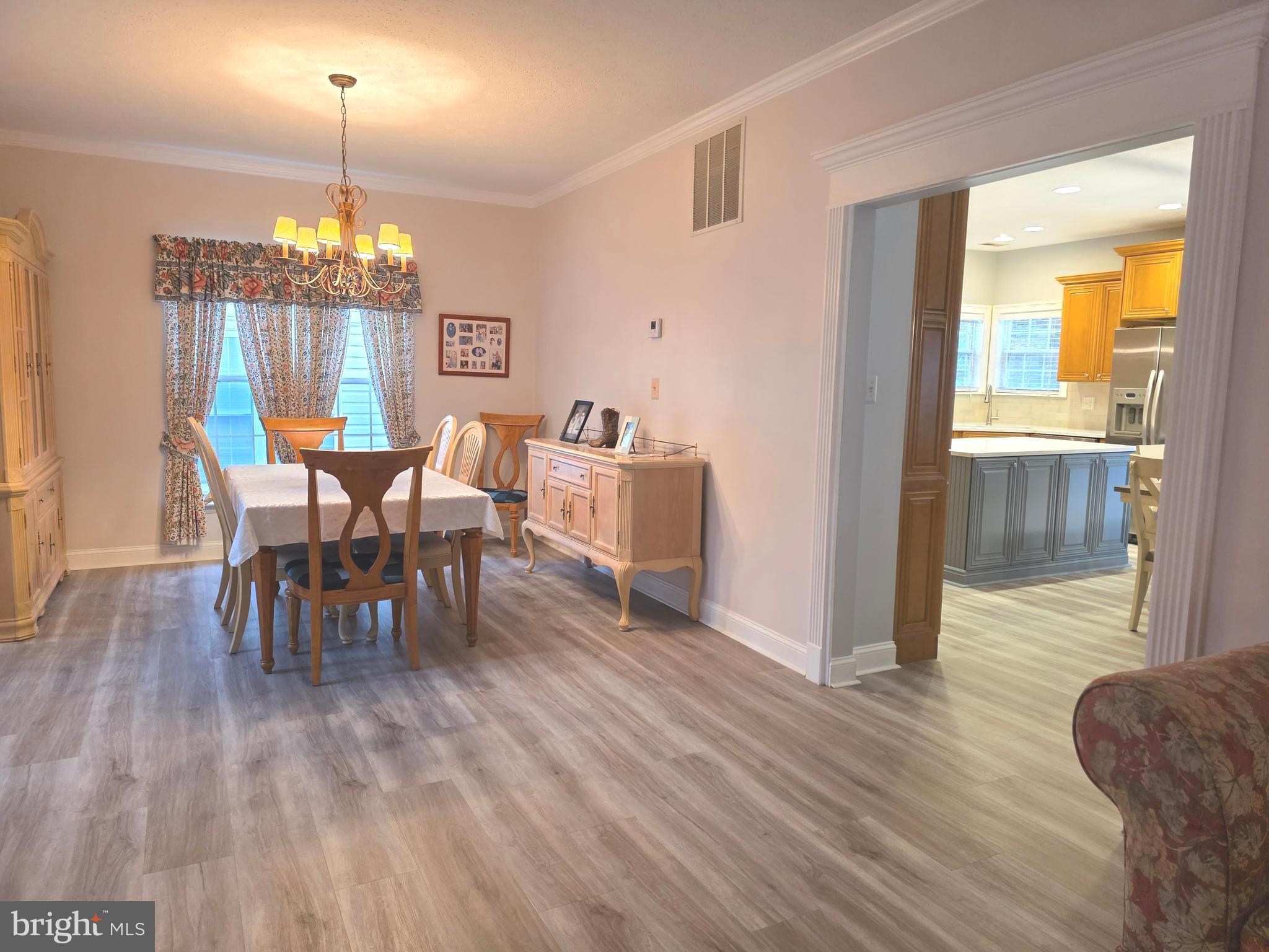 2441 Kemper Road Crofton, MD 21114 - Photo 7 of 63 a view of a dining room with furniture window and wooden floor