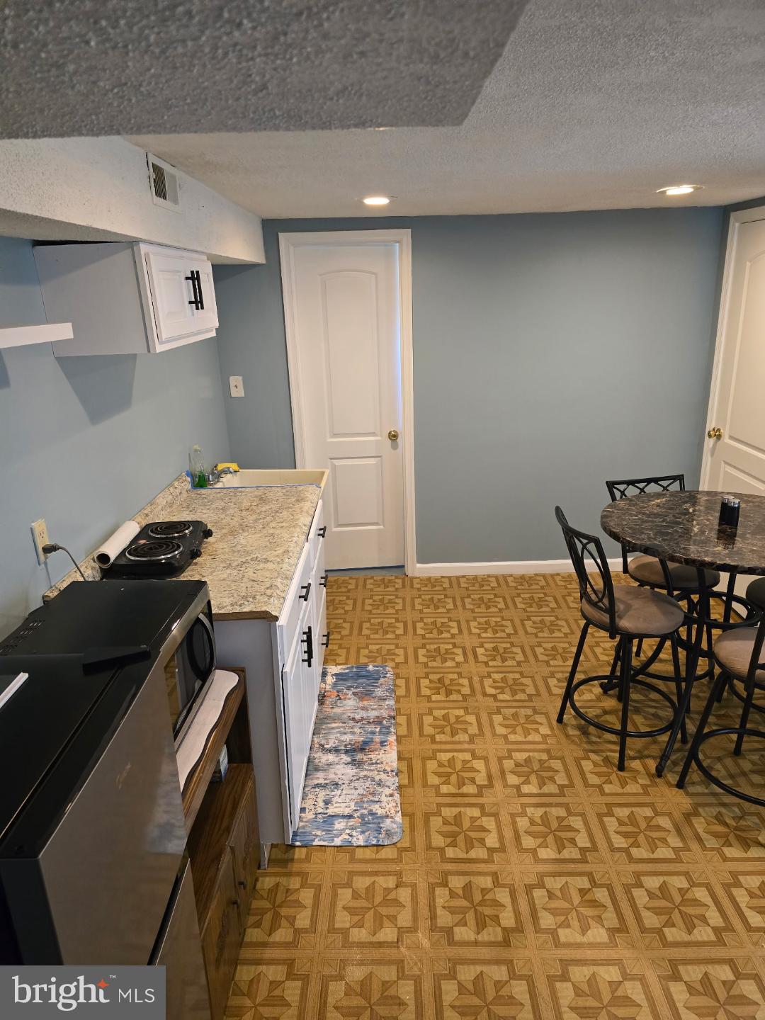 8512 Imperial Drive, Unit 1H Laurel, MD 20708 - Photo 9 of 14 a kitchen that has a sink and a stove