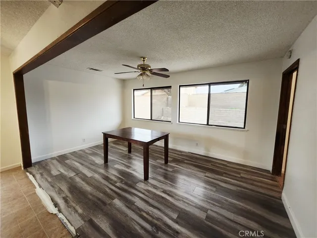 a view of a livingroom with wooden floor and furniture