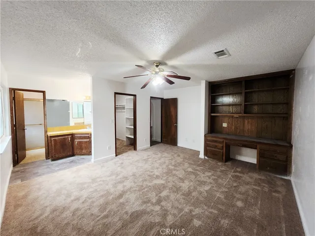 a view of an empty room with a fireplace