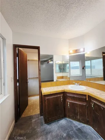 a view of a kitchen with a sink and dishwasher a refrigerator with wooden cabinets