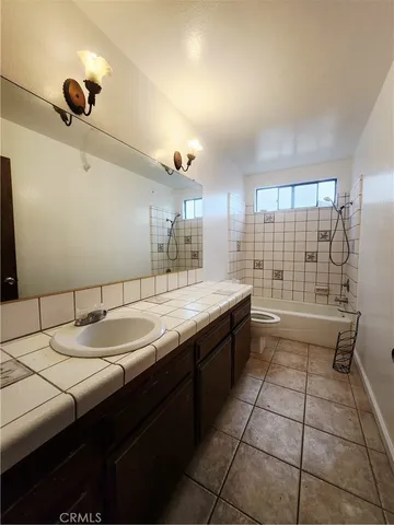 a large kitchen with kitchen island a sink stainless steel appliances and a counter space