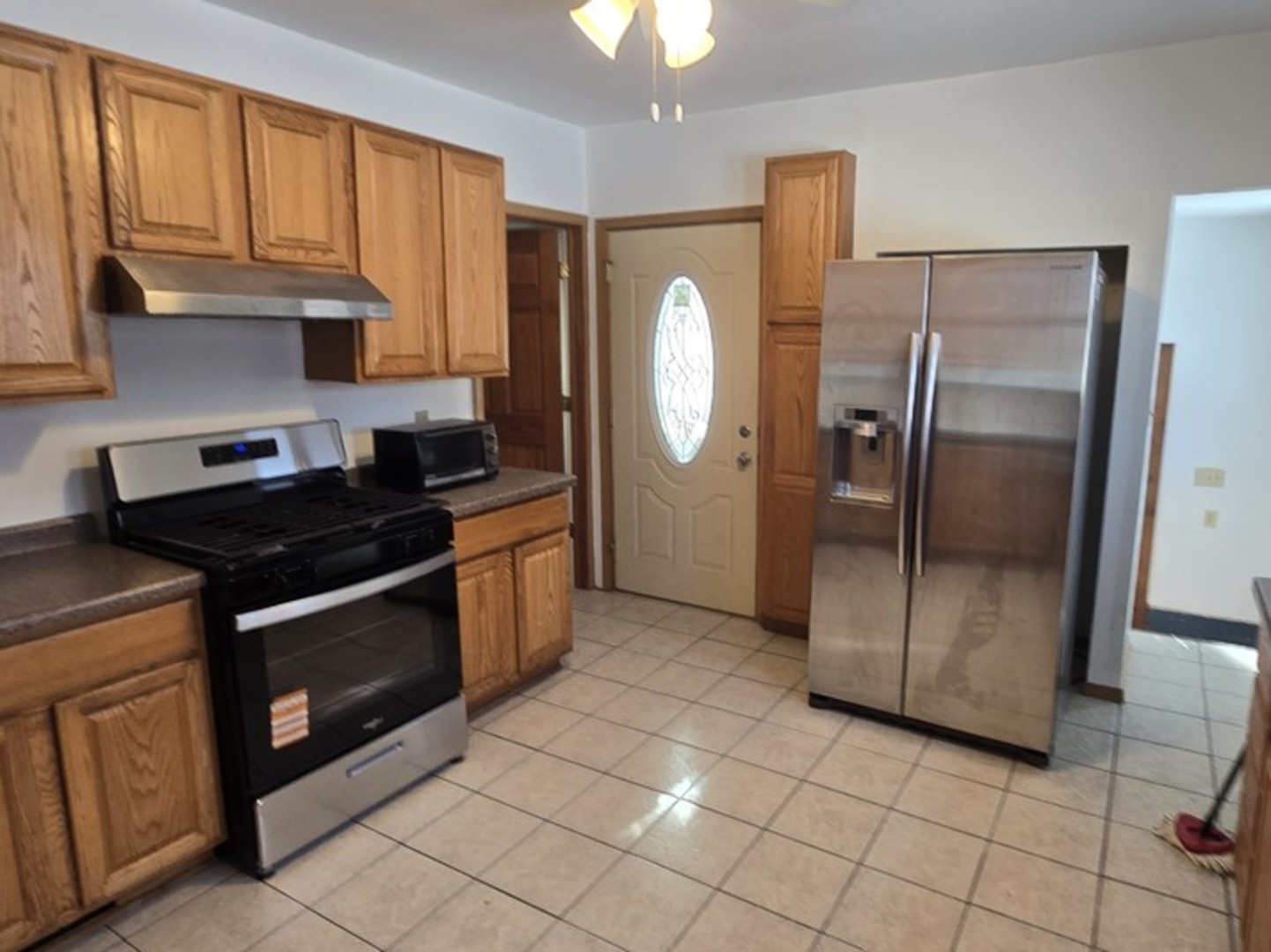 310 Genoa Road Genoa, IL 60135 - Photo 5 of 7 a kitchen with stainless steel appliances granite countertop a stove a refrigerator and a cabinets