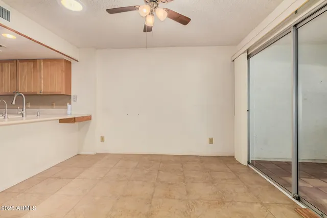 an empty room with projector and fan
