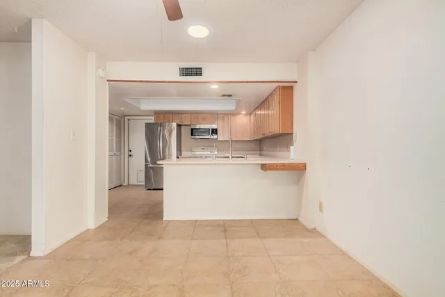 an empty room with a empty space and windows