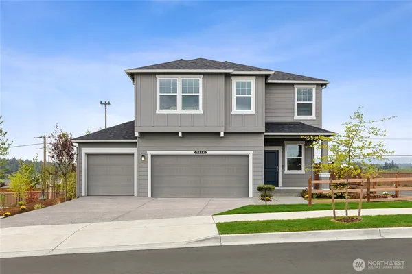 a front view of a house with a yard and garage