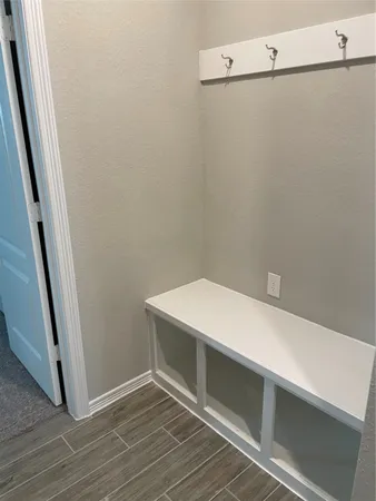 a room with linen closet and wooden floor