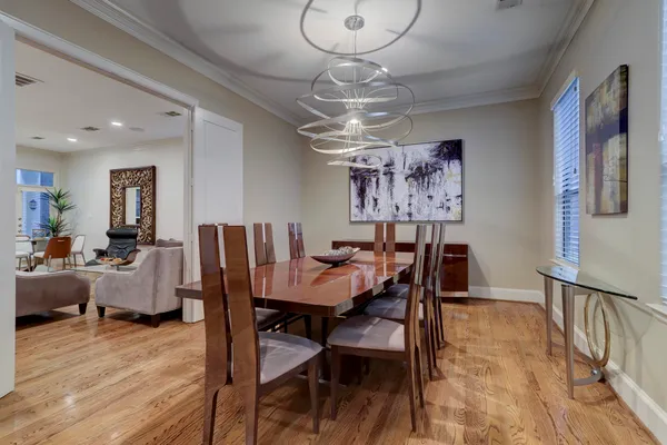 a view of a dining room with furniture wooden floor and chandelier