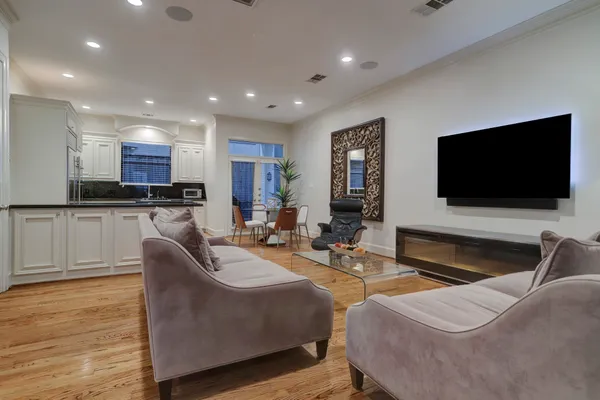 a living room with fireplace furniture and a flat screen tv