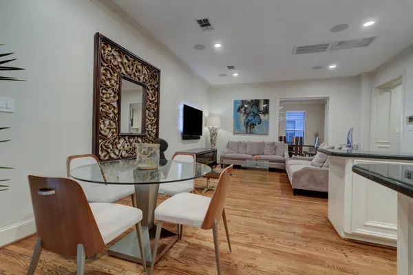 a living room with furniture a flat screen tv and kitchen view