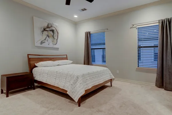a bedroom with a bed and a painting on the wall