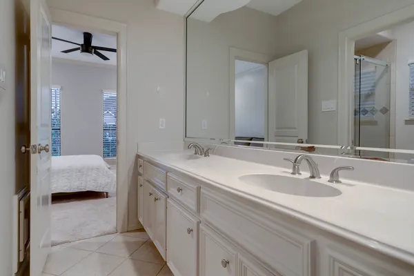 a en suite bathroom with a double vanity sink double and mirror