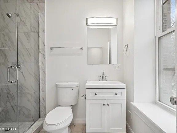 446 North Aberdeen Street, Unit 2 Chicago, IL 60642 - Photo 8 of 12 a bathroom with a sink a toilet and shower