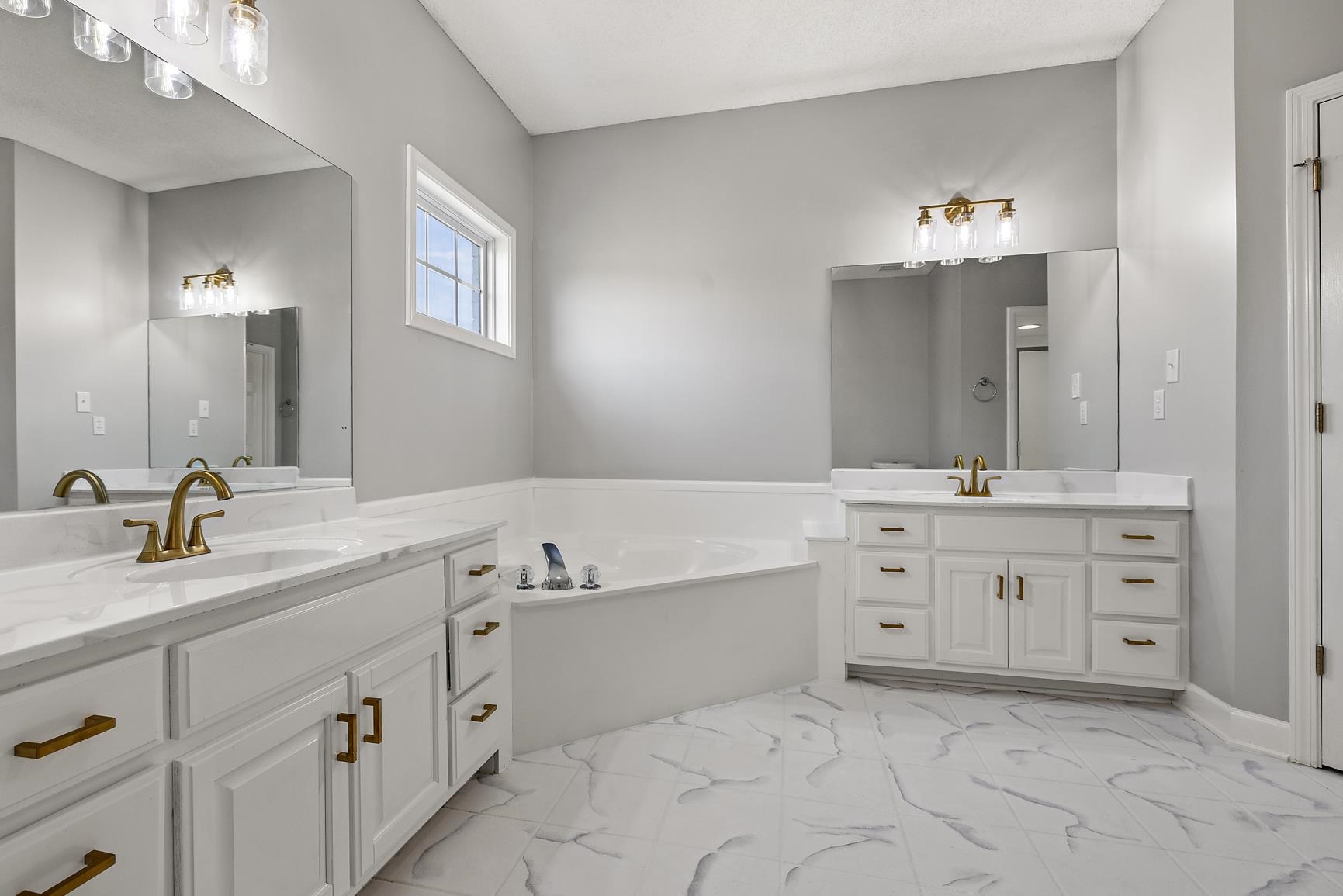 369 Rosemark Road Atoka, TN 38004 - Photo 12 of 27 a spacious bathroom with a granite countertop double vanity sink mirror and bathtub