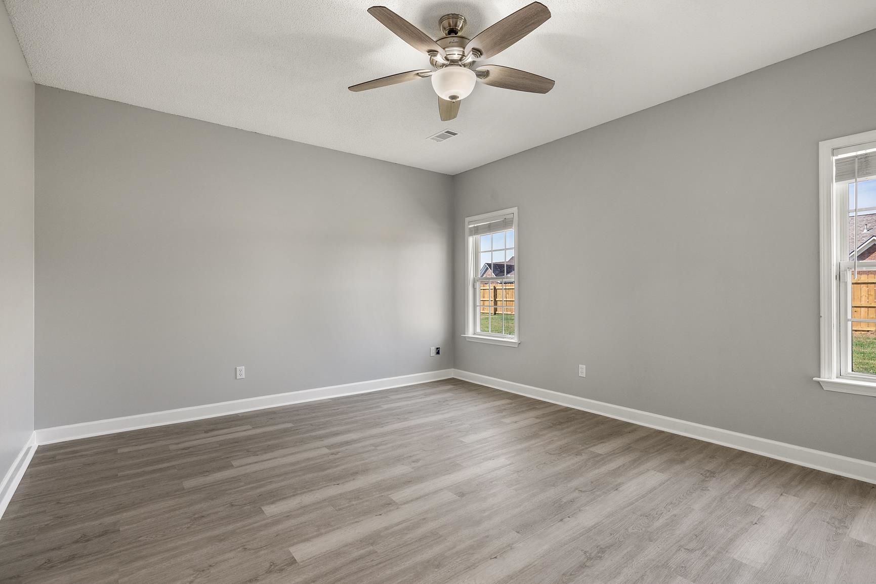 369 Rosemark Road Atoka, TN 38004 - Photo 14 of 27 a view of an empty room with a window and wooden floor