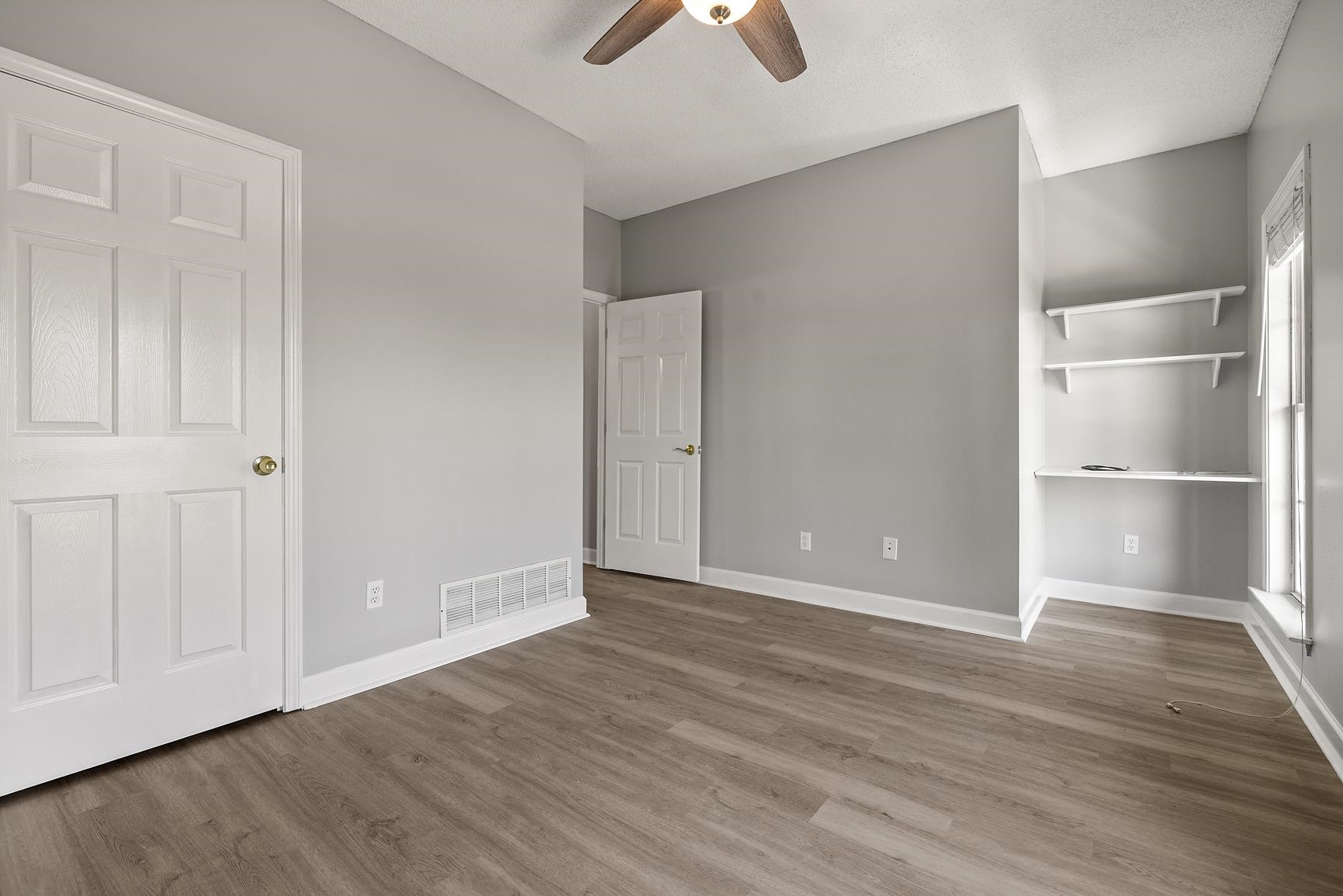 369 Rosemark Road Atoka, TN 38004 - Photo 17 of 27 an empty room with wooden floor and closet