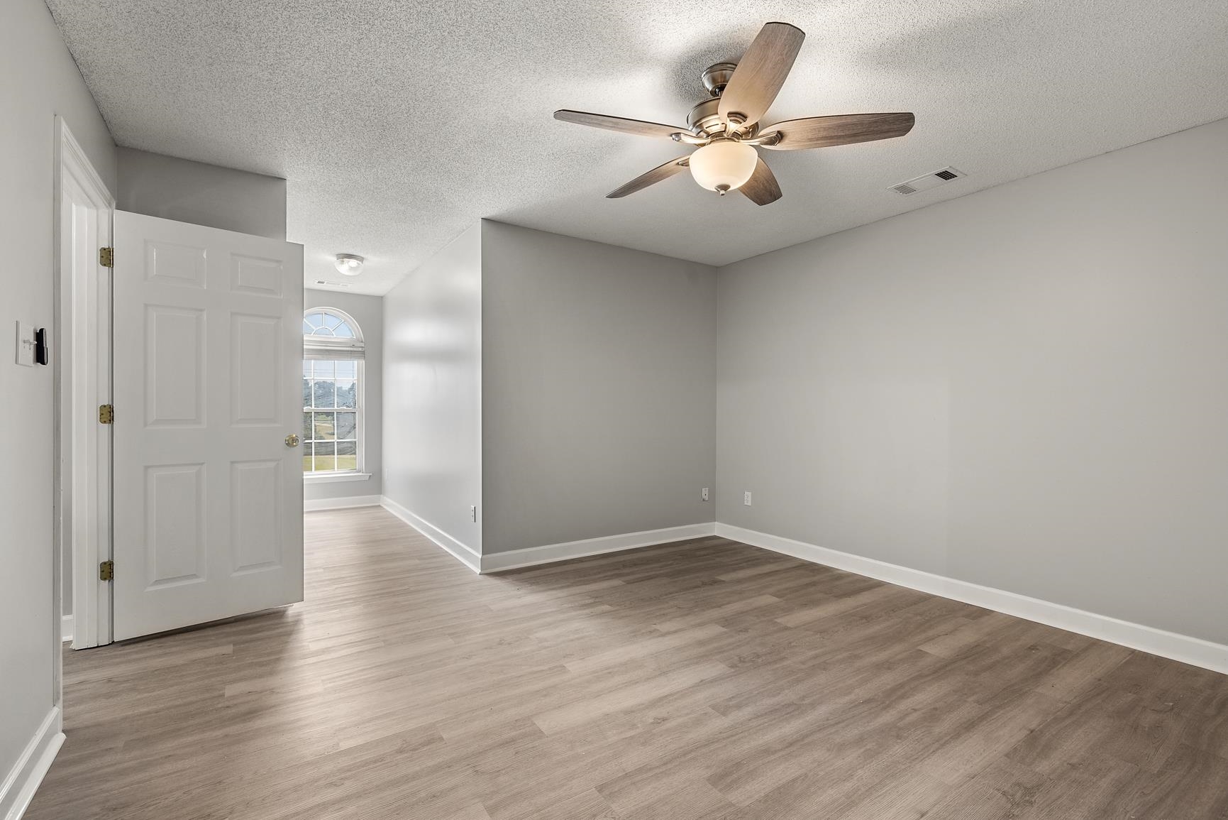 369 Rosemark Road Atoka, TN 38004 - Photo 21 of 27 wooden floor in an empty room with a window