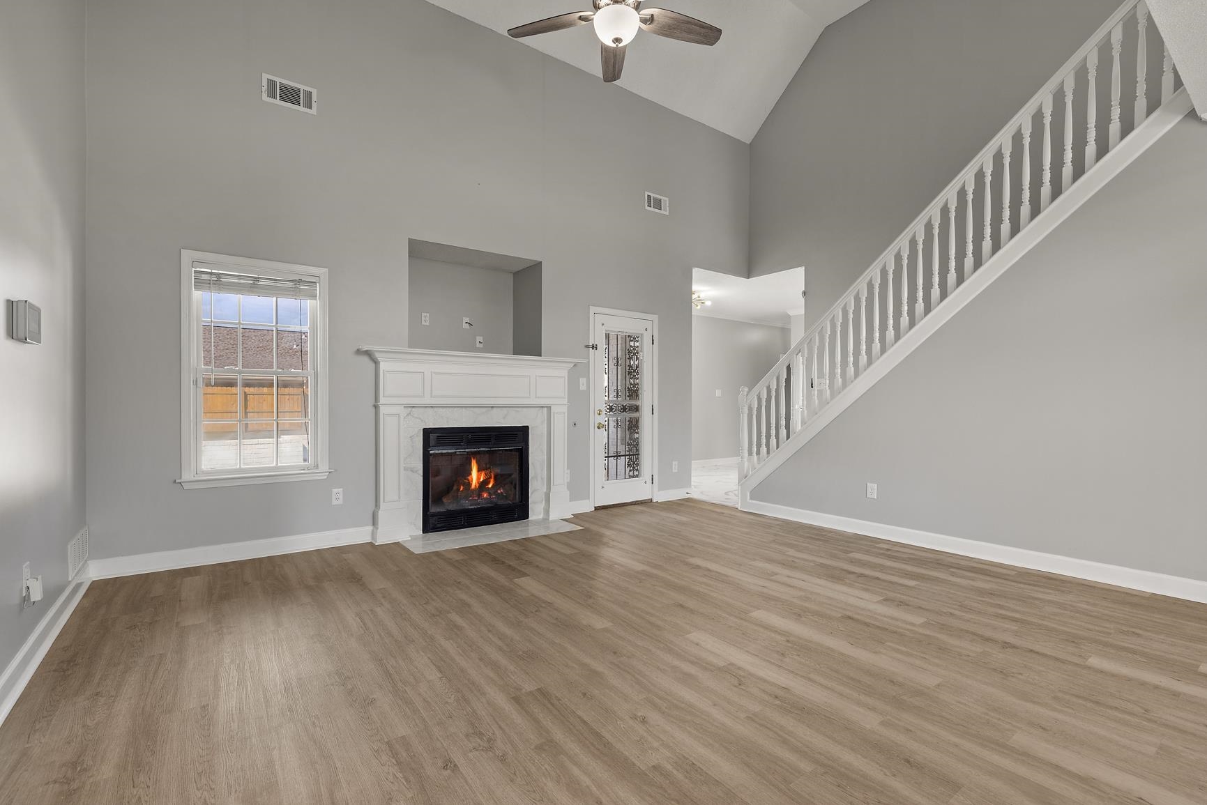 369 Rosemark Road Atoka, TN 38004 - Photo 5 of 27 a view of an empty room with wooden floor fireplace and a window