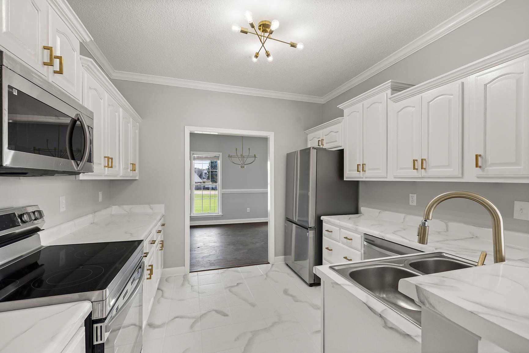 369 Rosemark Road Atoka, TN 38004 - Photo 7 of 27 a kitchen with stainless steel appliances a stove a sink and a microwave